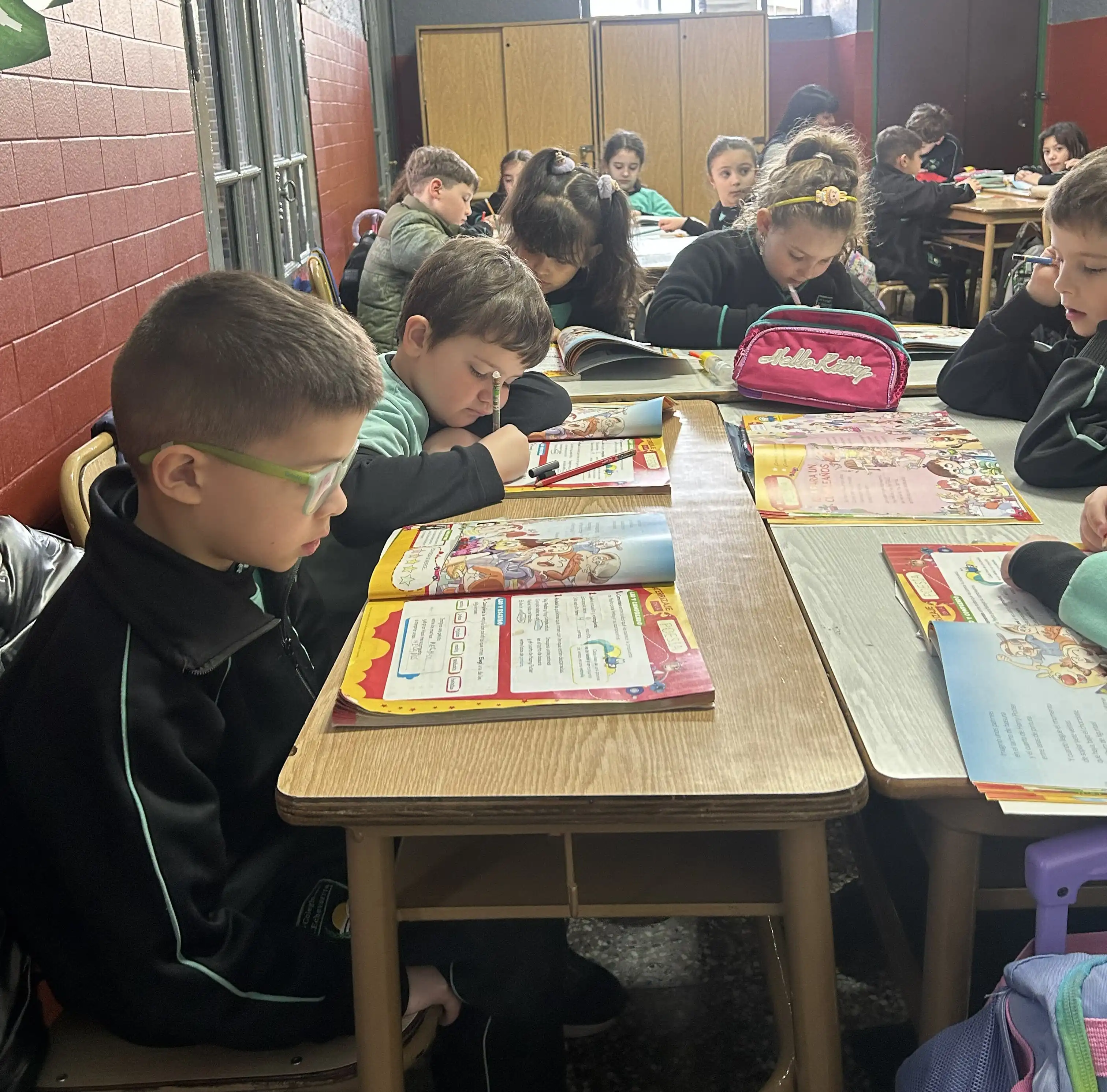 Alumnos del Nivel Primario del Colegio Echeverría participando en actividades de lectura, comprensión y producción escrita en el aula.